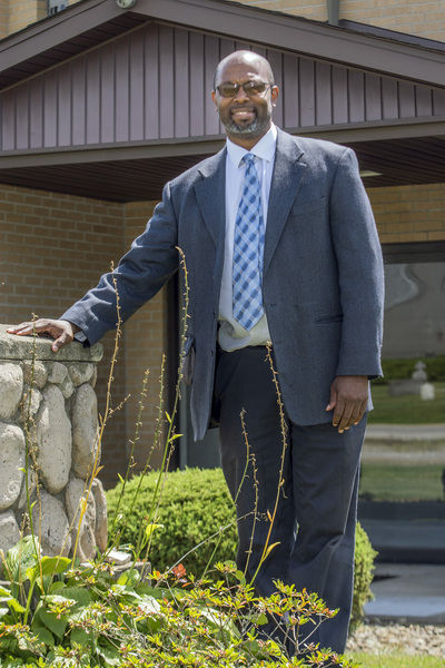 Harrison wears many hats; 'father' is his most important church